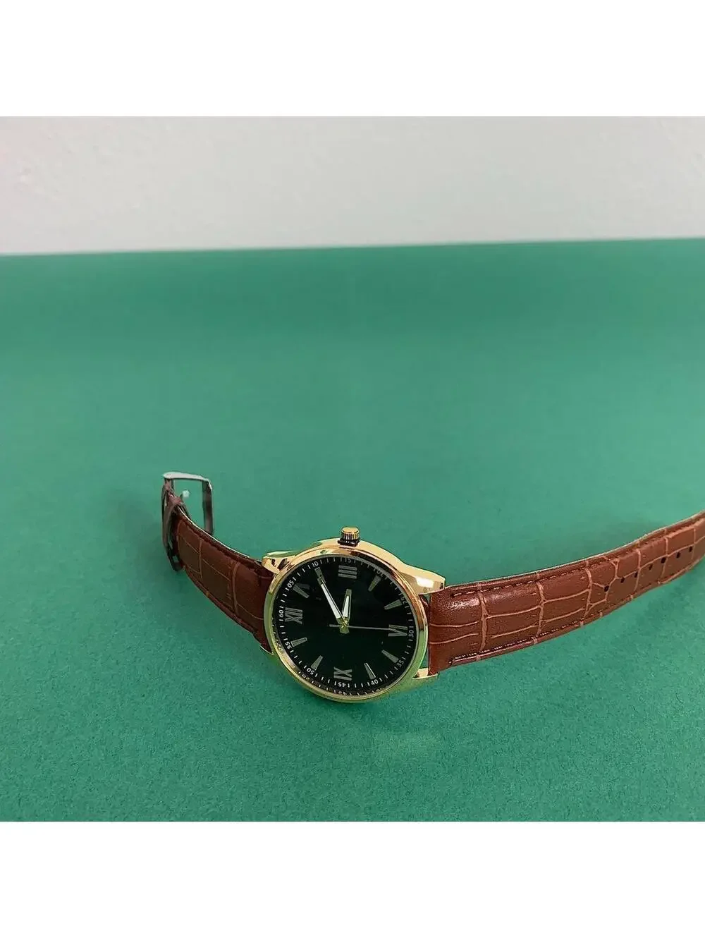 Minimalistic Black essential vintage style gold and leather style band watch. 9
